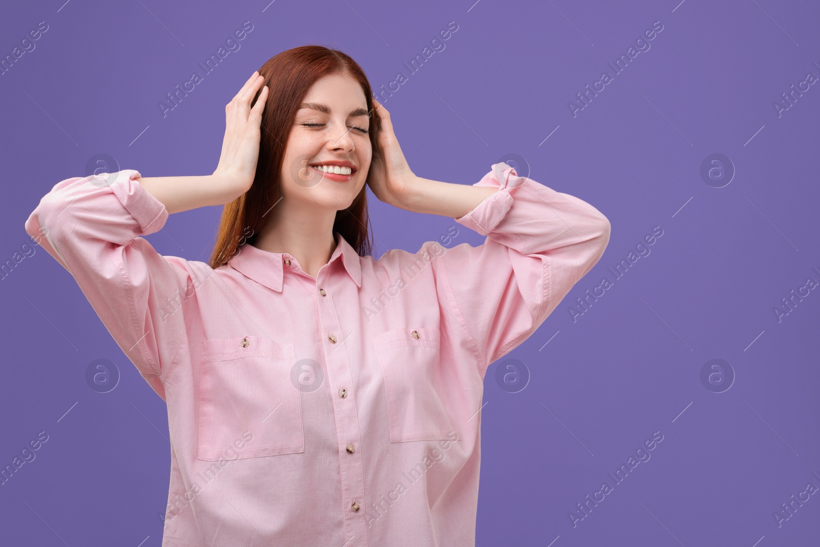 Photo of Portrait of smiling woman on purple background. Space for text