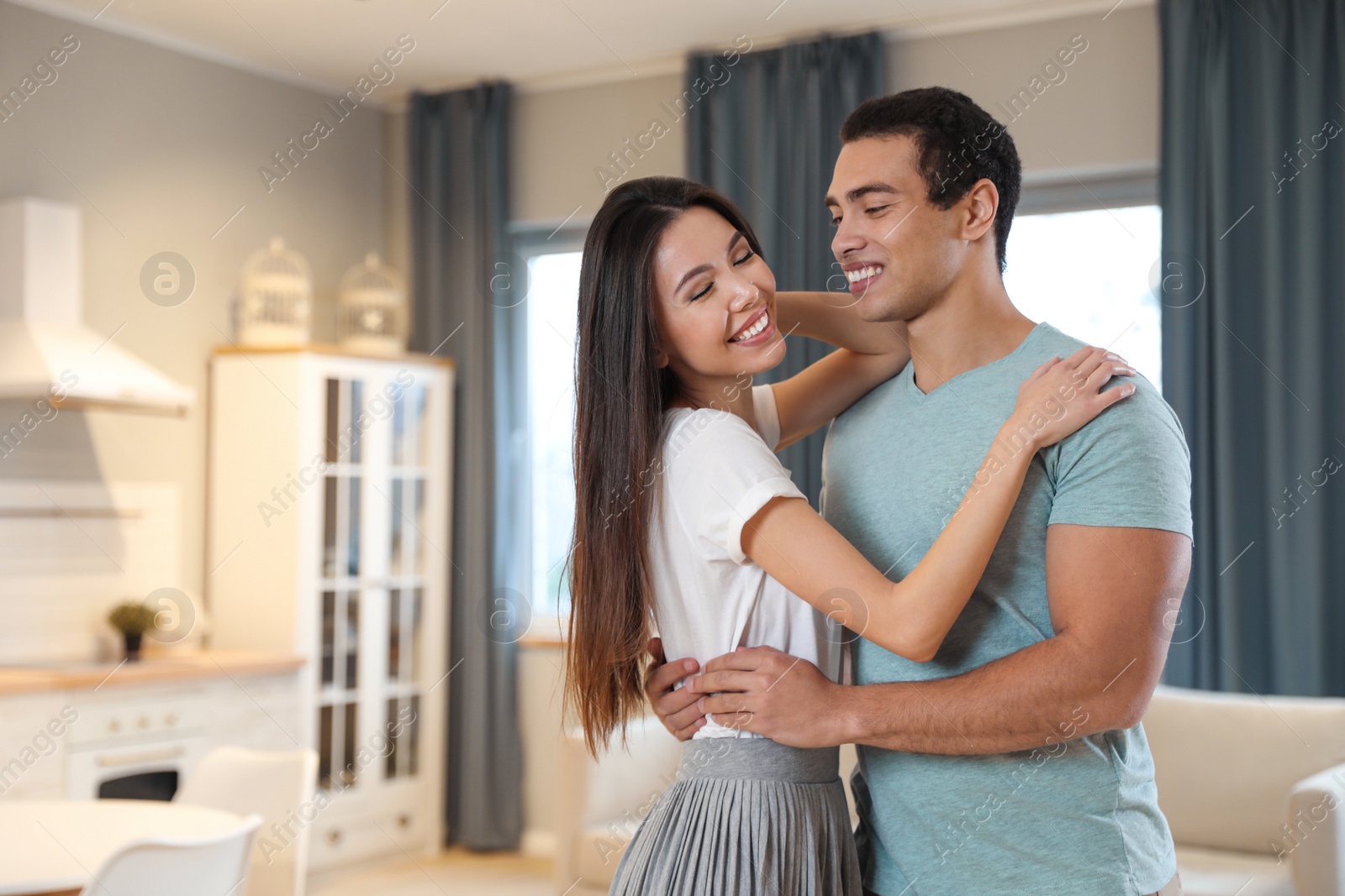 Photo of Lovely young interracial couple dancing at home