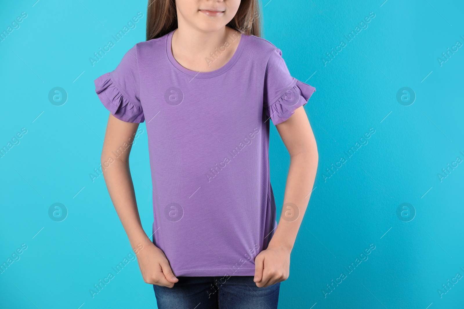 Photo of Little girl in t-shirt on color background. Mockup for design