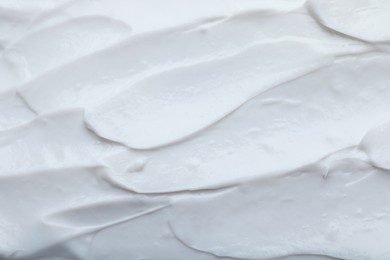 Photo of Closeup view of white body cream as background