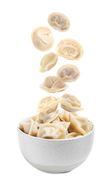 Image of Many tasty dumplings falling into bowl on white background