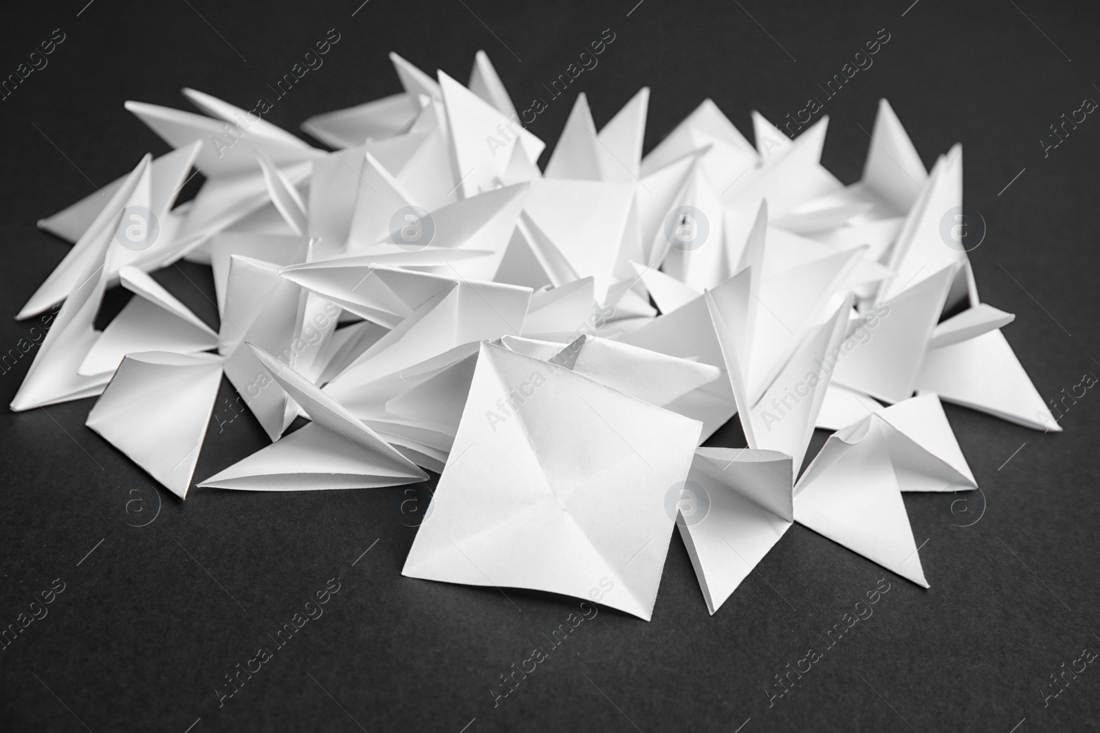 Photo of Pile of paper pieces for lottery on dark background