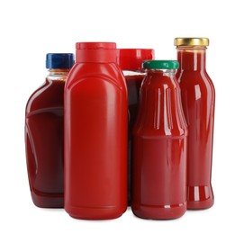 Photo of Different bottles of ketchup on white background