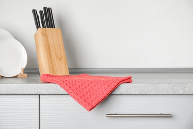 Photo of Fabric coral towel on table in kitchen