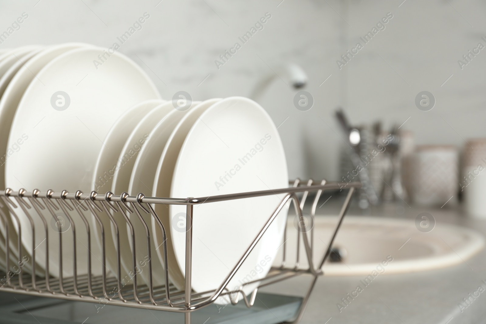 Photo of Drying rack with clean dishes on kitchen counter. Space for text