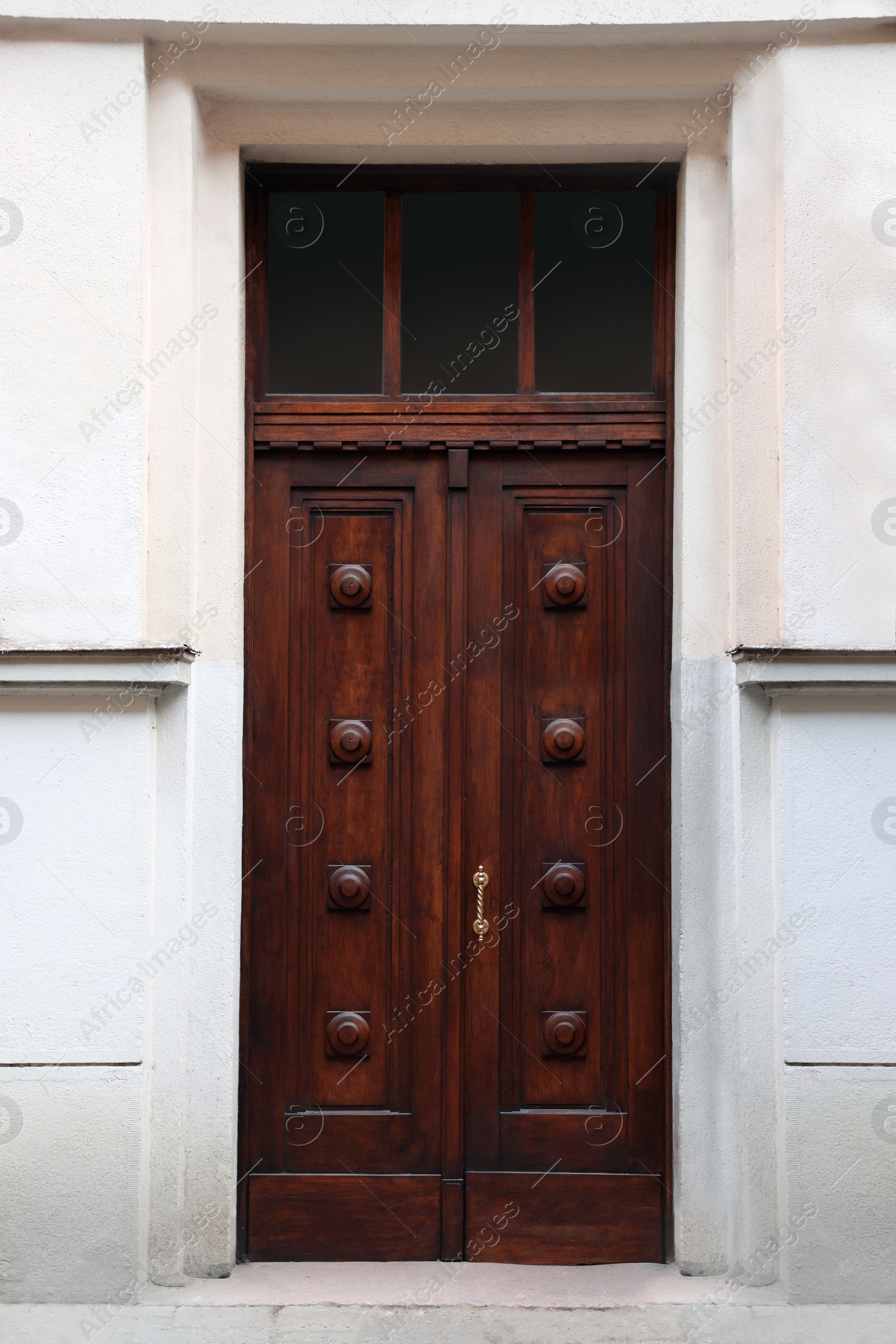 Photo of Entrance of house with beautiful wooden door and transom window