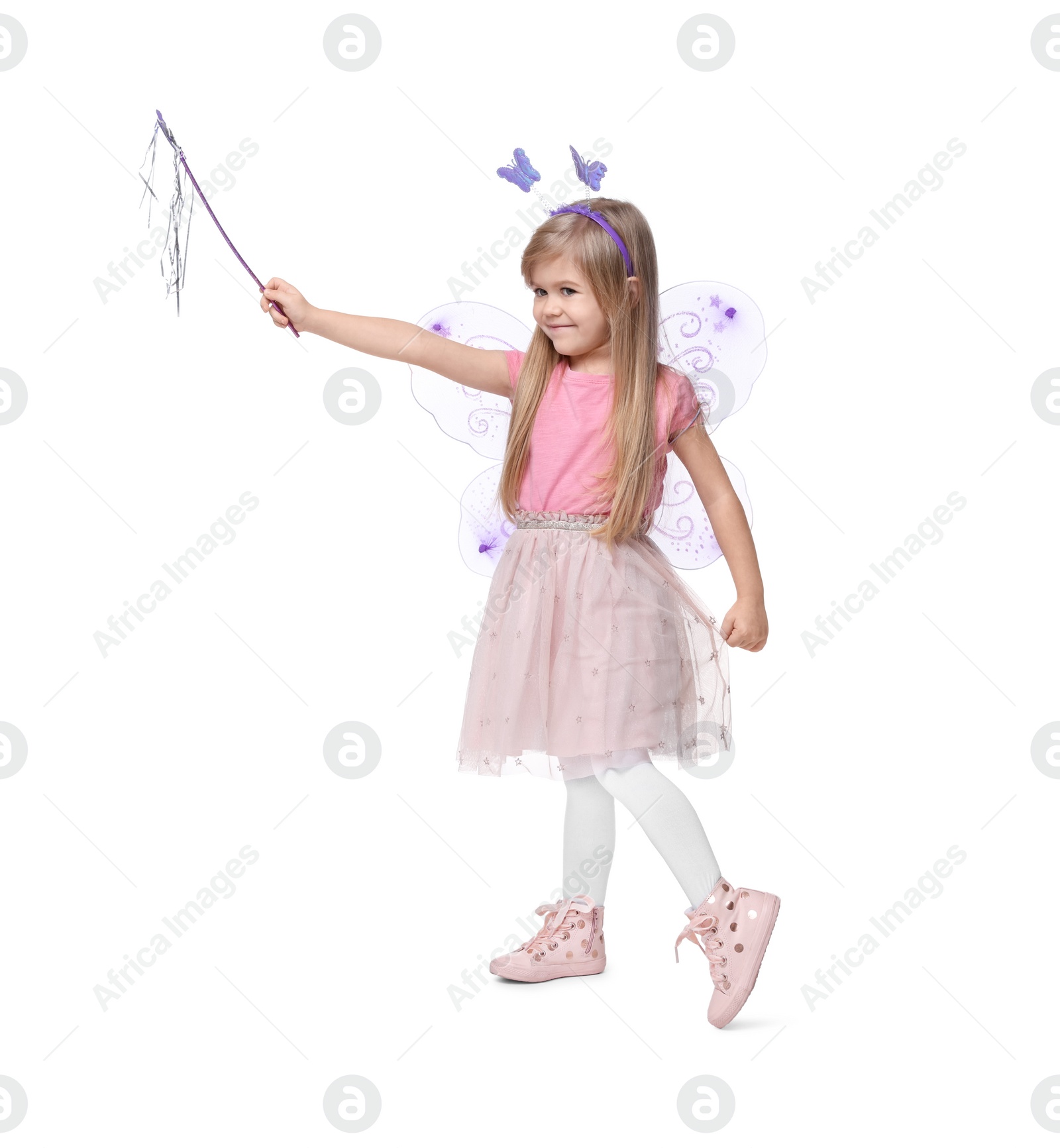 Photo of Cute little girl in fairy costume with violet wings and magic wand on white background