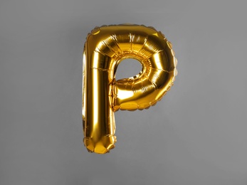 Golden letter P balloon on grey background