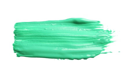 Photo of Abstract brushstroke of green paint isolated on white