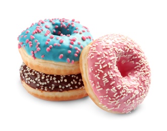 Delicious glazed doughnuts with sprinkles on white background