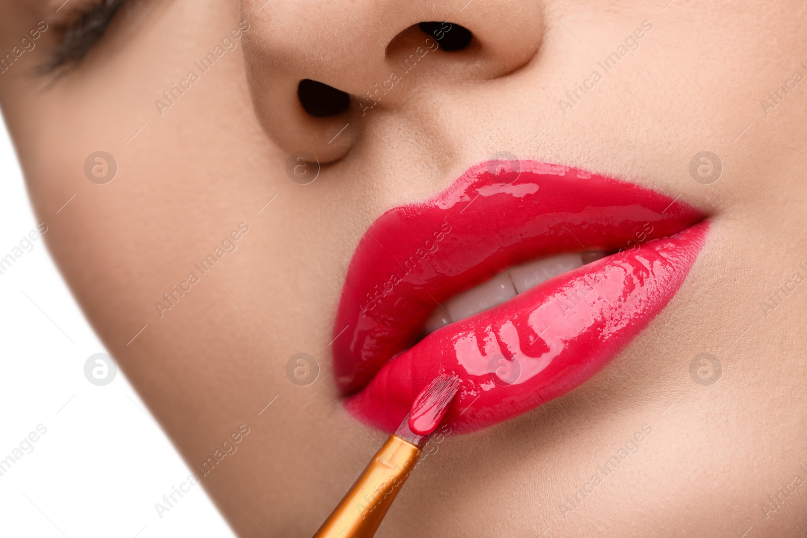 Photo of Woman applying lip gloss on white background, closeup