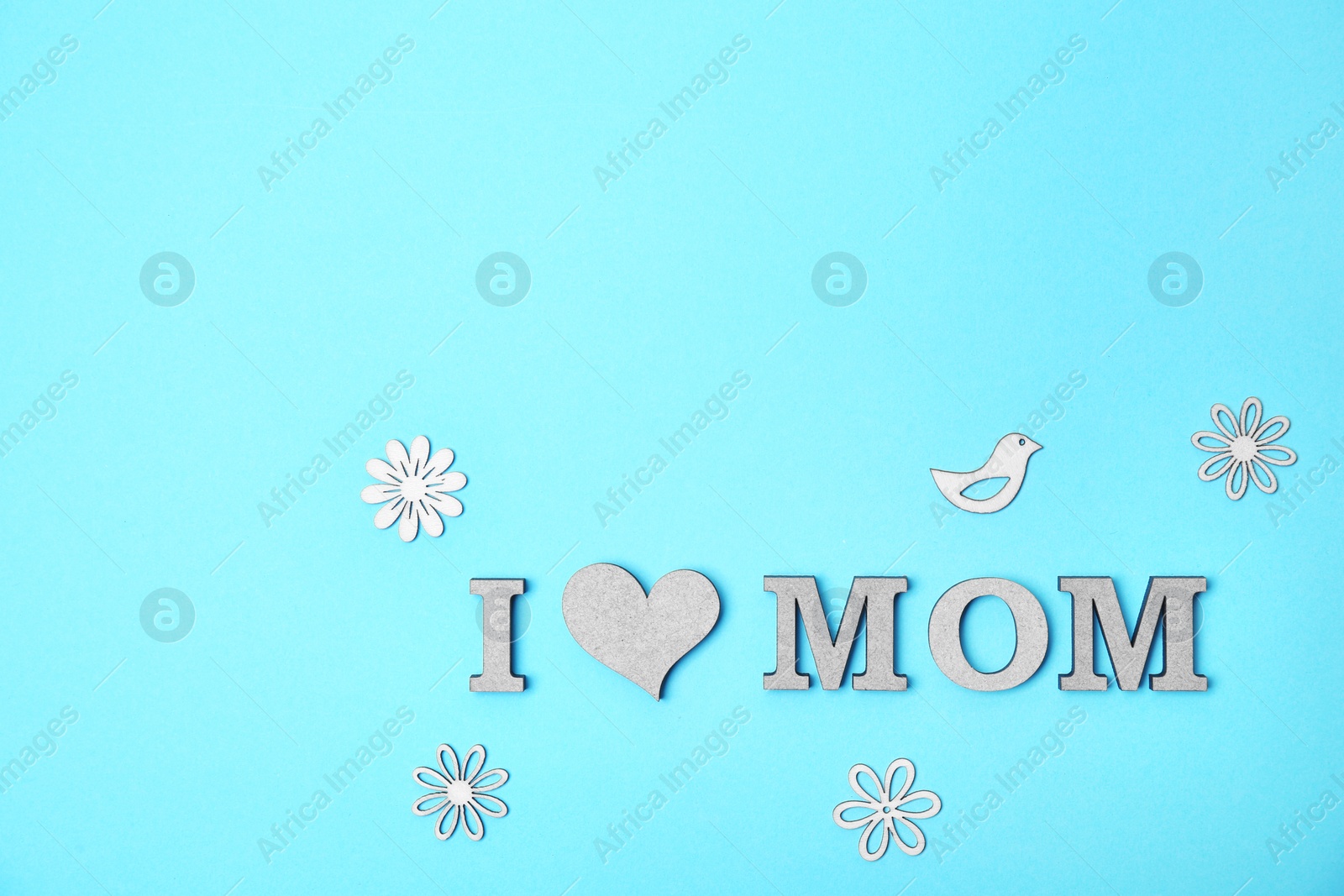 Photo of Phrase "I LOVE MOM" made of letters on color background. Happy Mother's Day