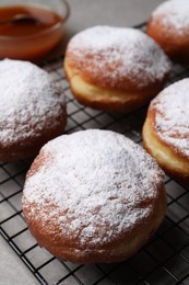 Delicious sweet buns with powdered sugar on table, closeup