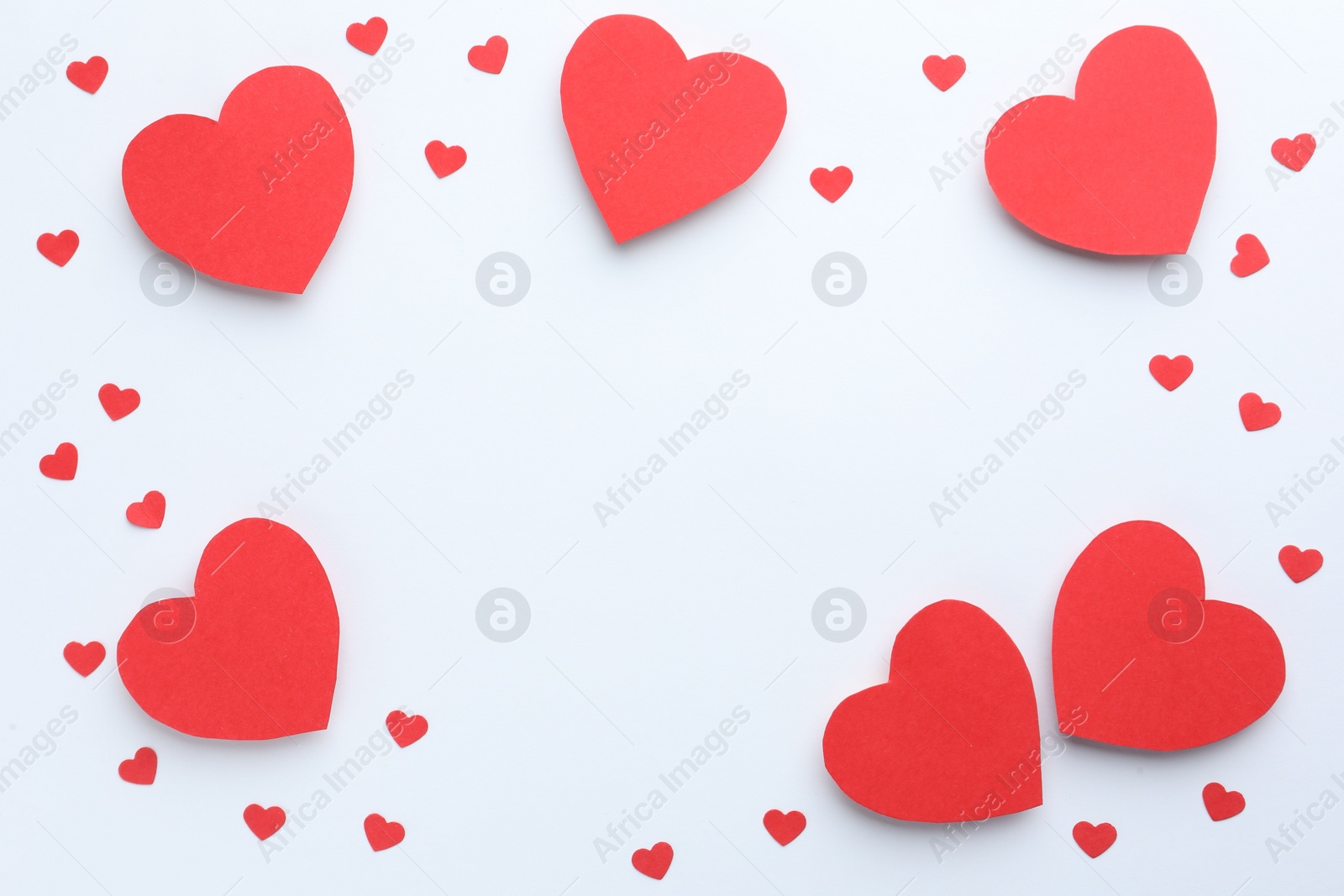 Photo of Frame of beautiful red paper hearts on white background, flat lay. Space for text