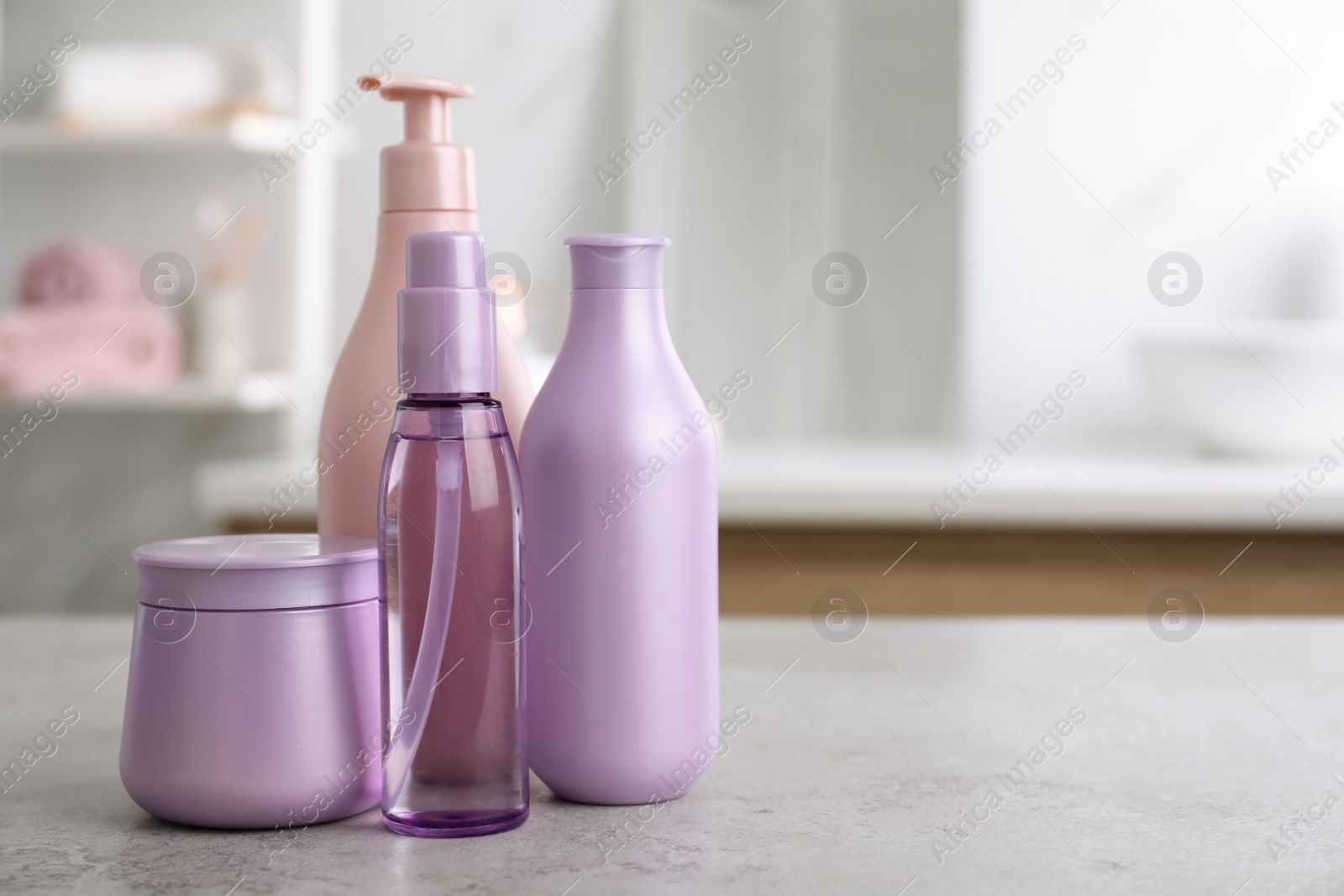 Photo of Different hair care products on table in bathroom, space for text