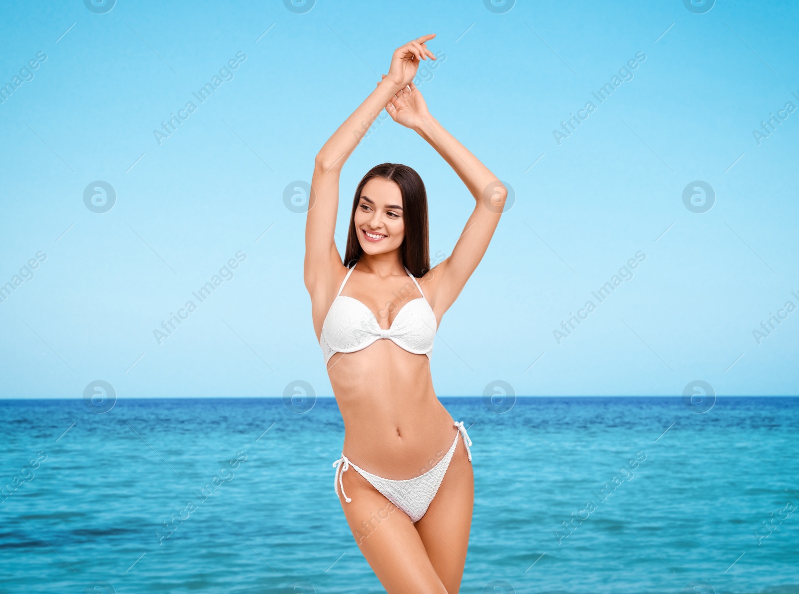 Image of Happy woman in stylish white bikini near sea