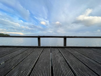 Photo of Picturesque view of river wooden pier and cloudy sky