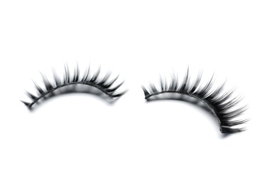 Beautiful pair of false eyelashes on white background