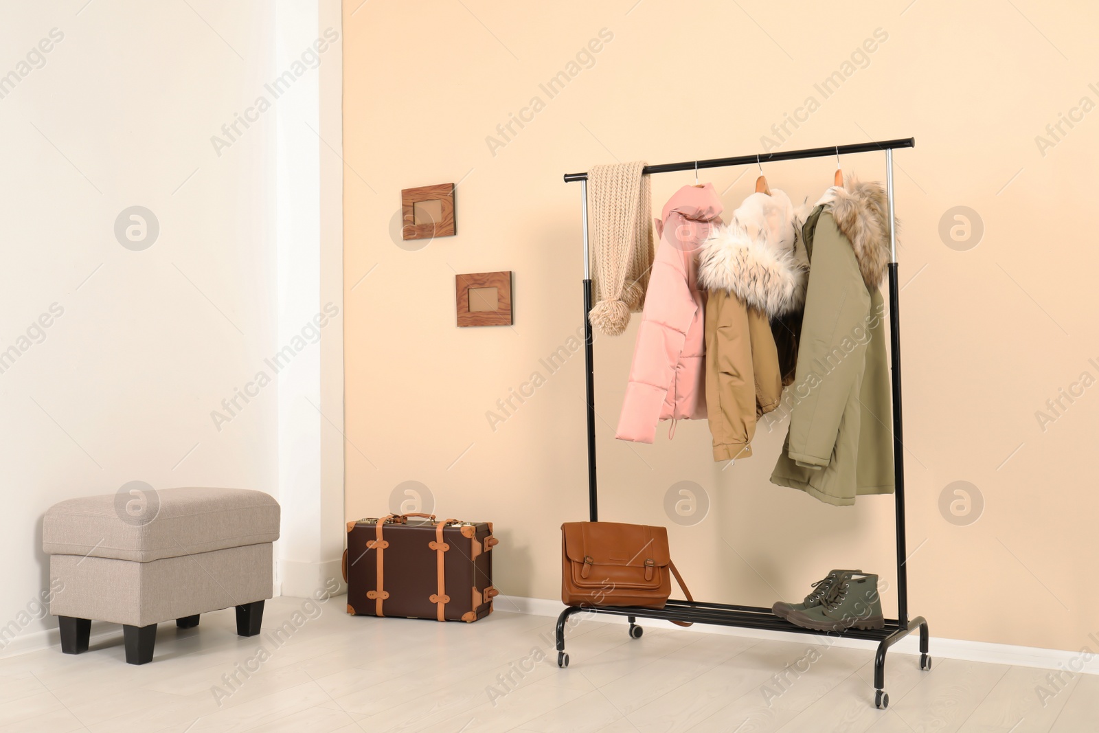 Photo of Stylish hallway interior with clothes on hanger stand