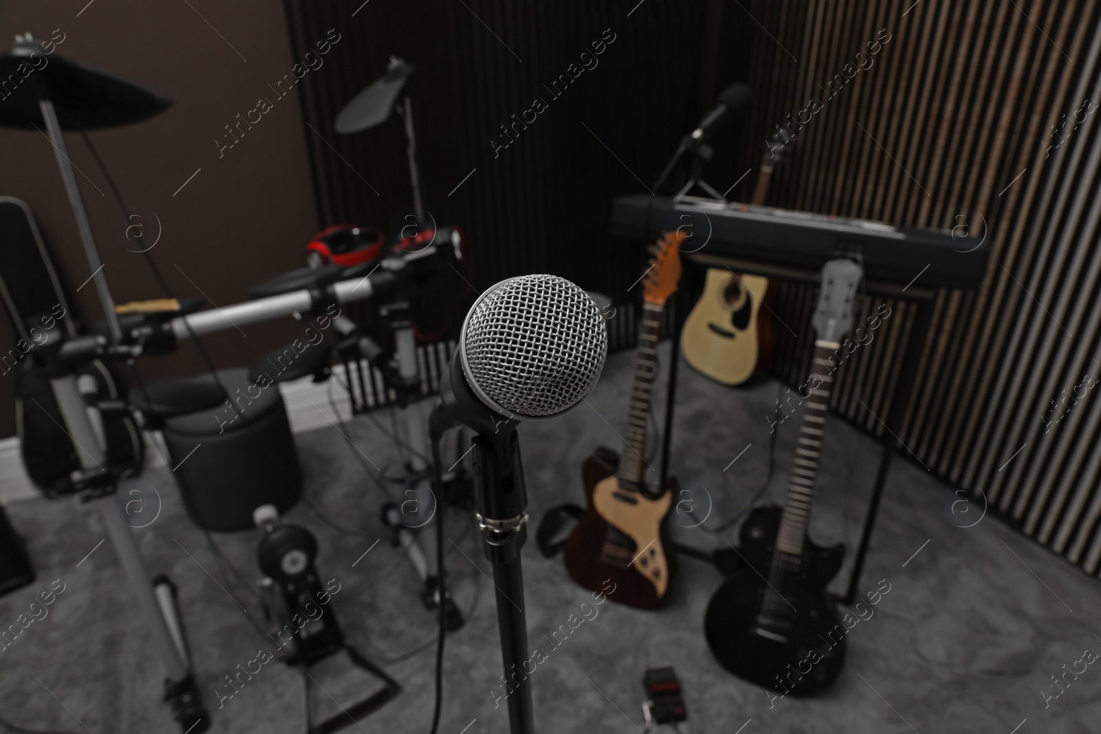 Photo of Modern microphone at recording studio. Music band practice