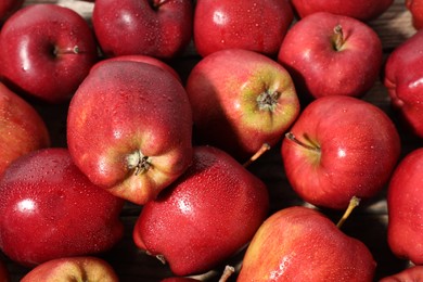 Photo of Many fresh apples with water drops as background, above view