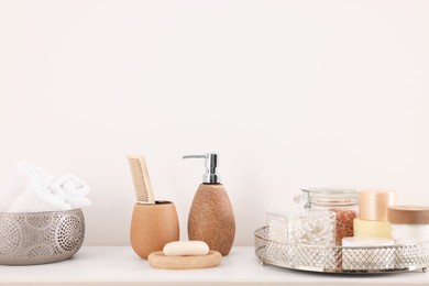 Different bath accessories and personal care products on white table