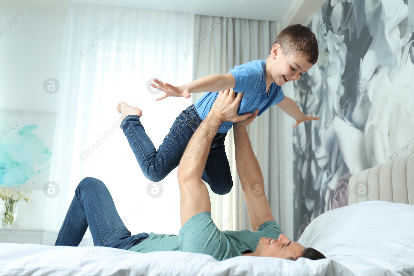 Photo of Dad and son having fun together at home. Happy Father's Day