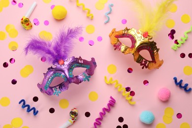 Photo of Flat lay composition with carnival items on pink background