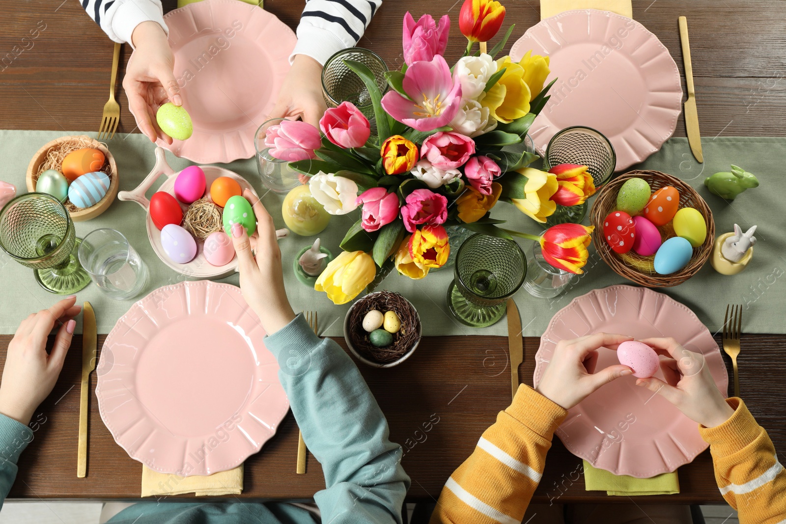 Photo of Festive table setting. Women celebrating Easter at home, top view