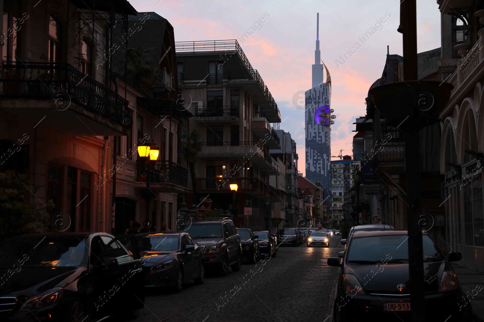 Photo of BATUMI, GEORGIA - MAY 31, 2022: Beautiful city street with buildings and cars in evening