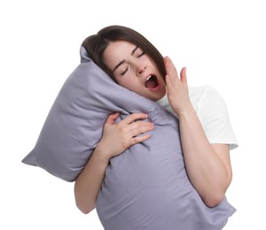 Photo of Sleepy young woman with pillow yawning on white background. Insomnia problem