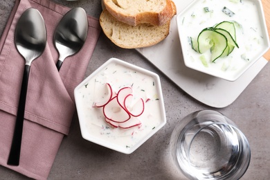 Photo of Delicious cold summer soup on grey table, flat lay