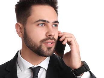 Young businessman talking on smartphone against white background