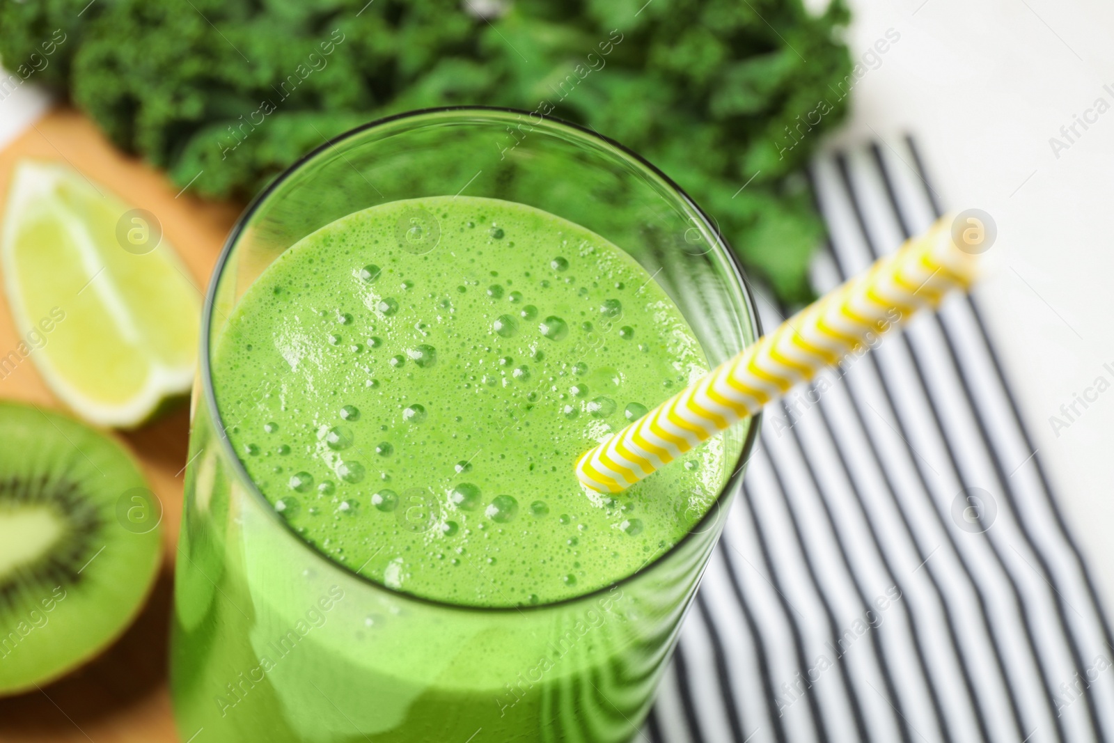 Photo of Tasty fresh kale smoothie on table, closeup