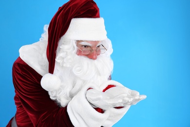 Portrait of Santa Claus on light blue background