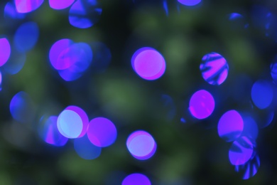 Photo of Abstract background with blurred violet Christmas lights, bokeh effect