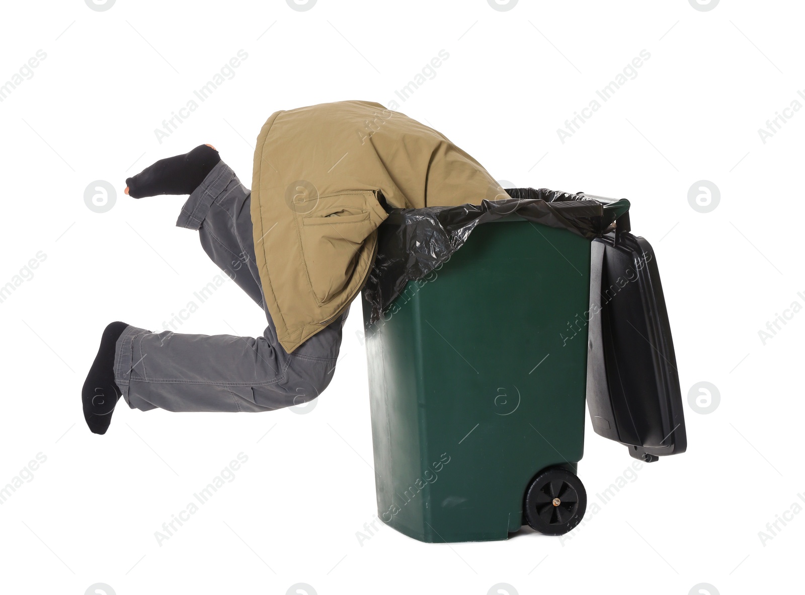 Photo of Poor homeless man digging in trash bin isolated on white