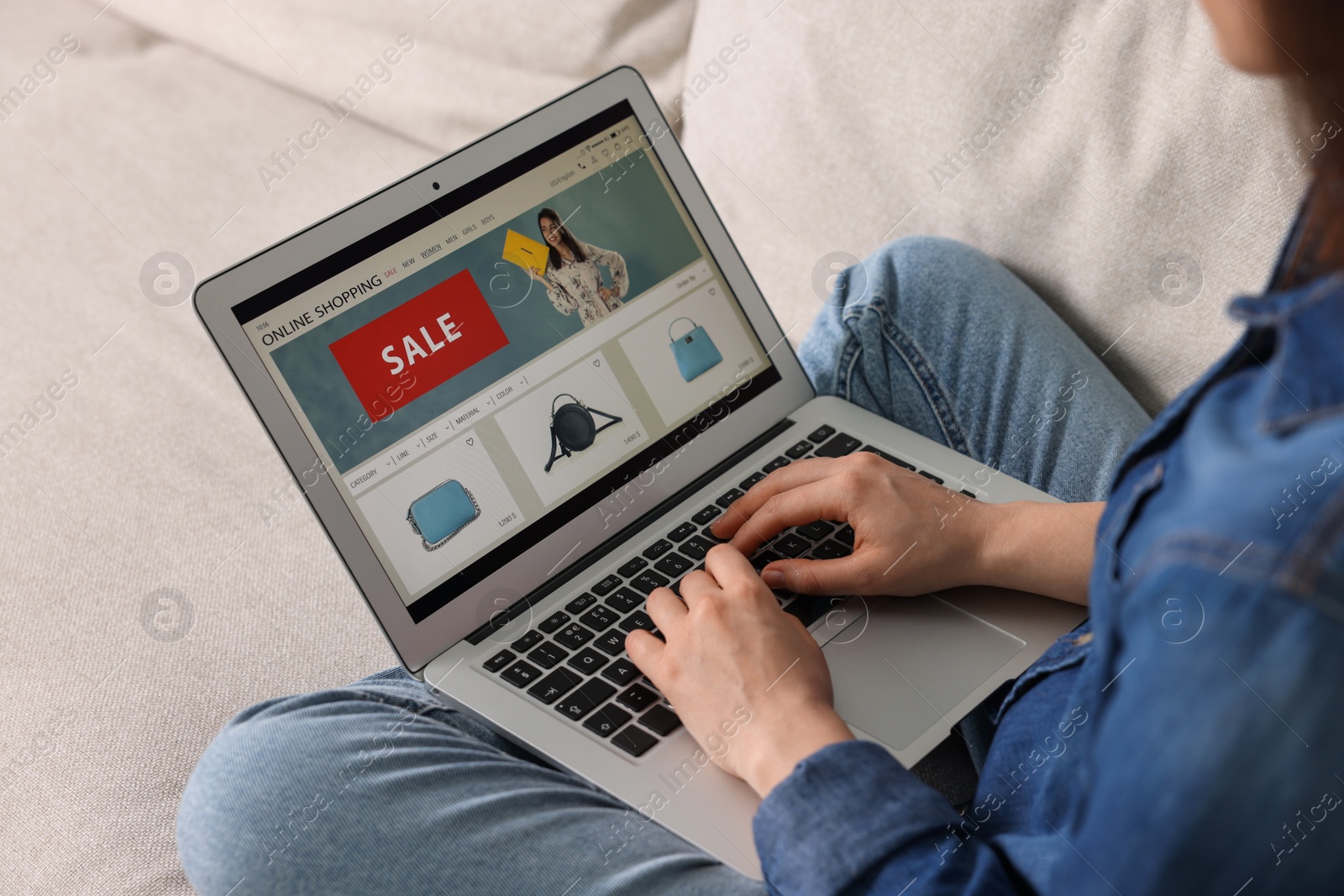 Photo of Woman shopping online during sale on laptop at home, closeup