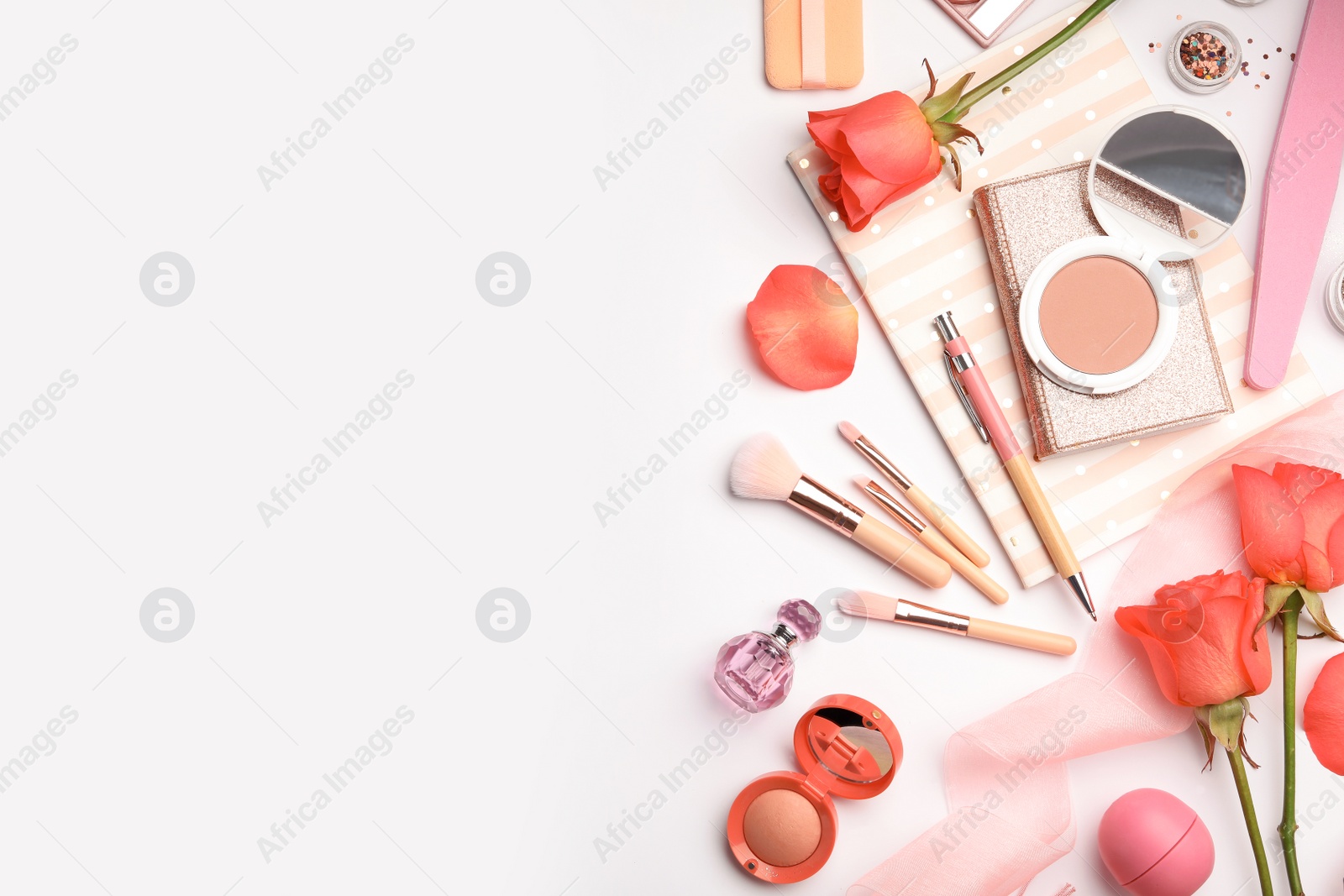 Photo of Flat lay composition with coral accessories, notebooks and roses on white background. Space for text