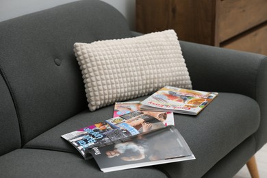 Different magazines on sofa in living room