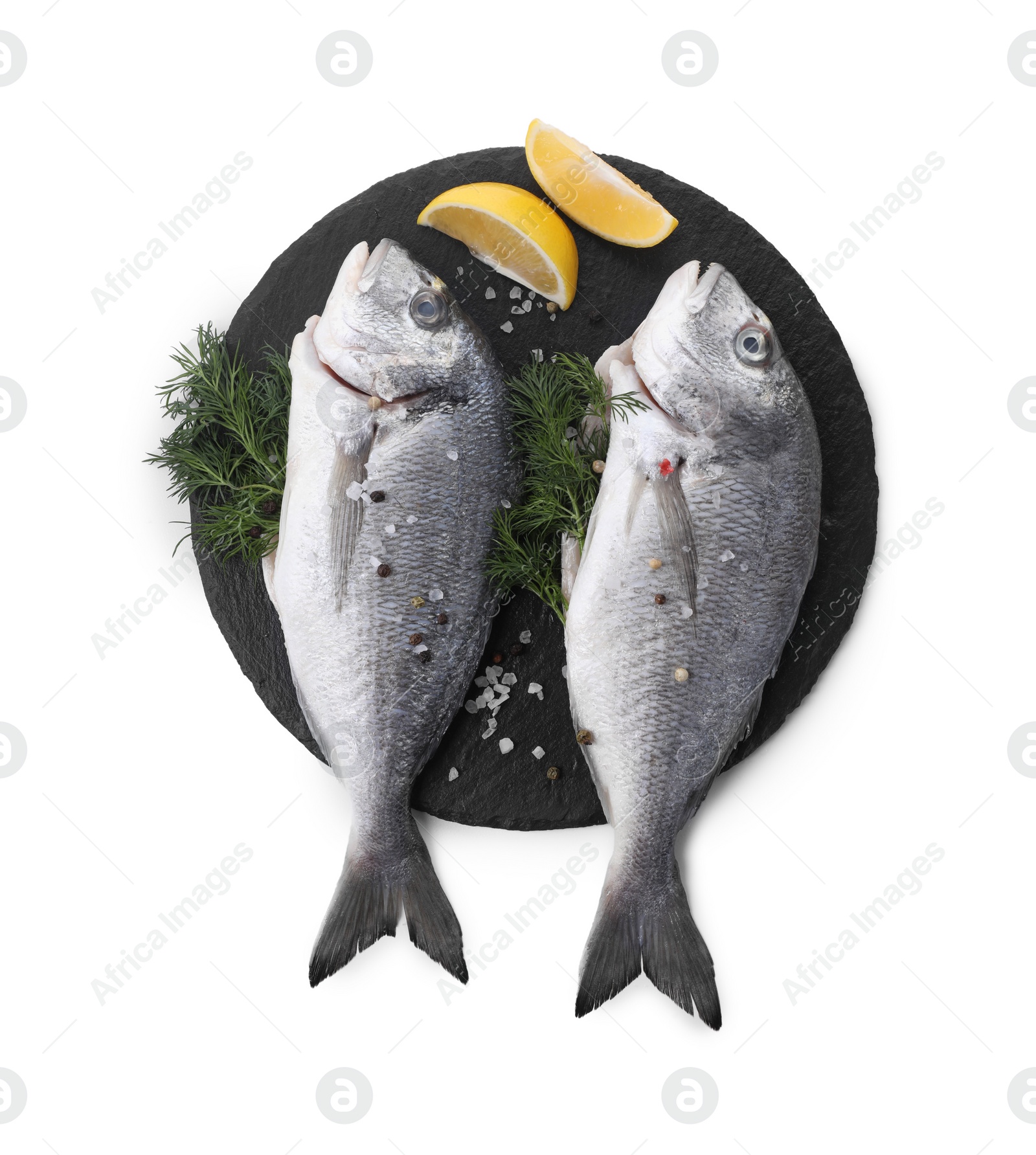 Photo of Raw dorado fish, dill, lemon wedges and peppercorns isolated on white, top view