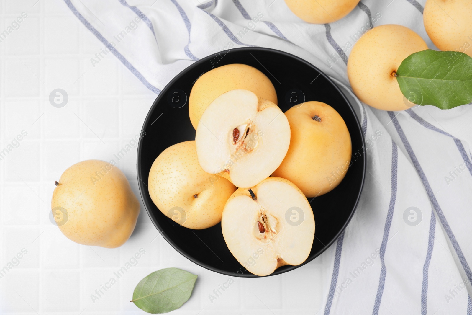 Photo of Delicious apple pears on white tiled table, flat lay
