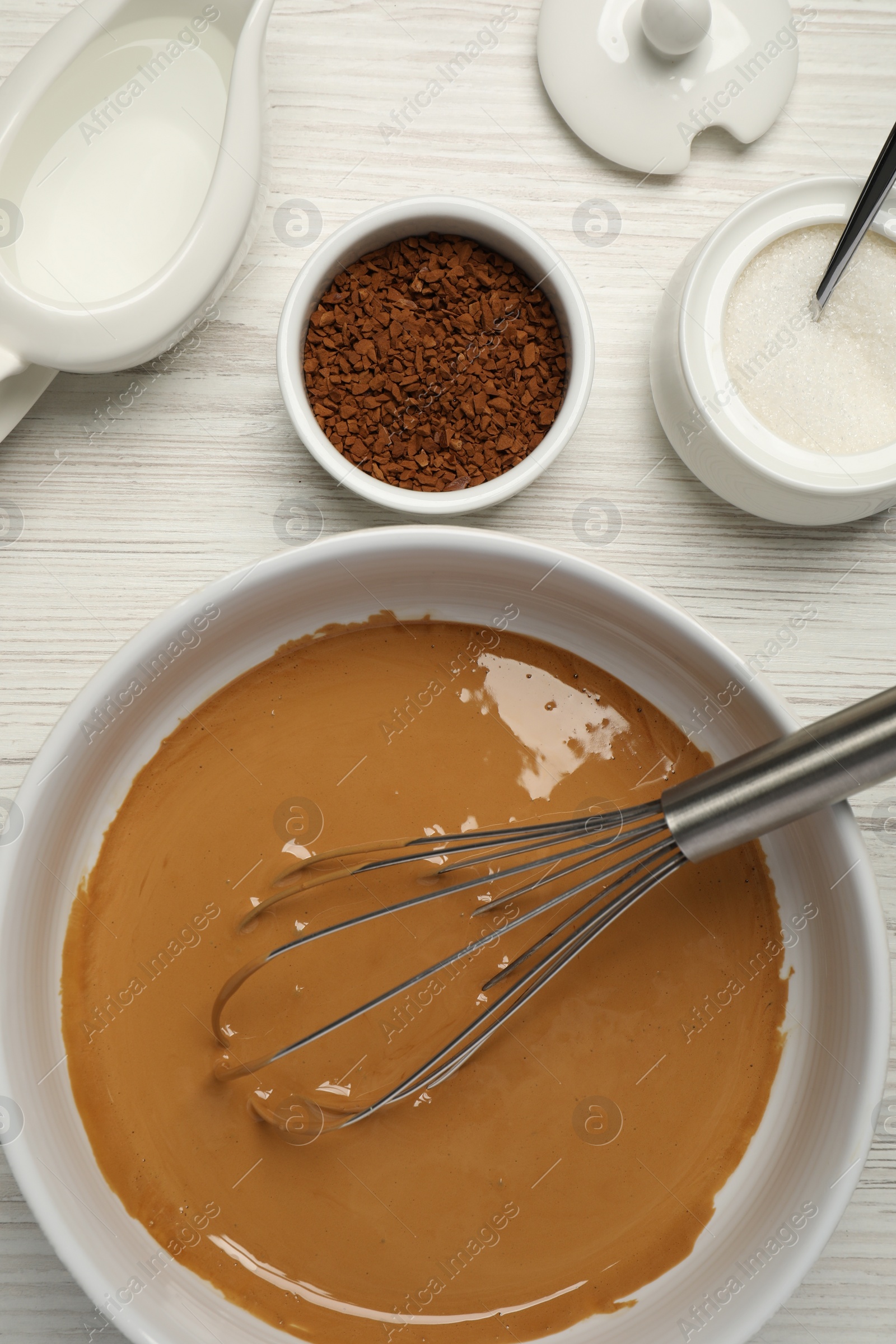 Photo of Whipping cream for dalgona coffee and ingredients on white wooden table, flat lay