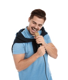 Photo of Young handsome man in casual clothes singing with microphone on white background