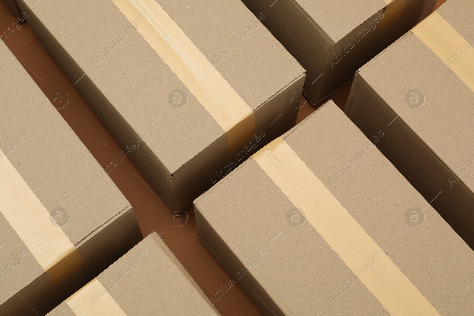 Photo of Many cardboard boxes on brown background, flat lay