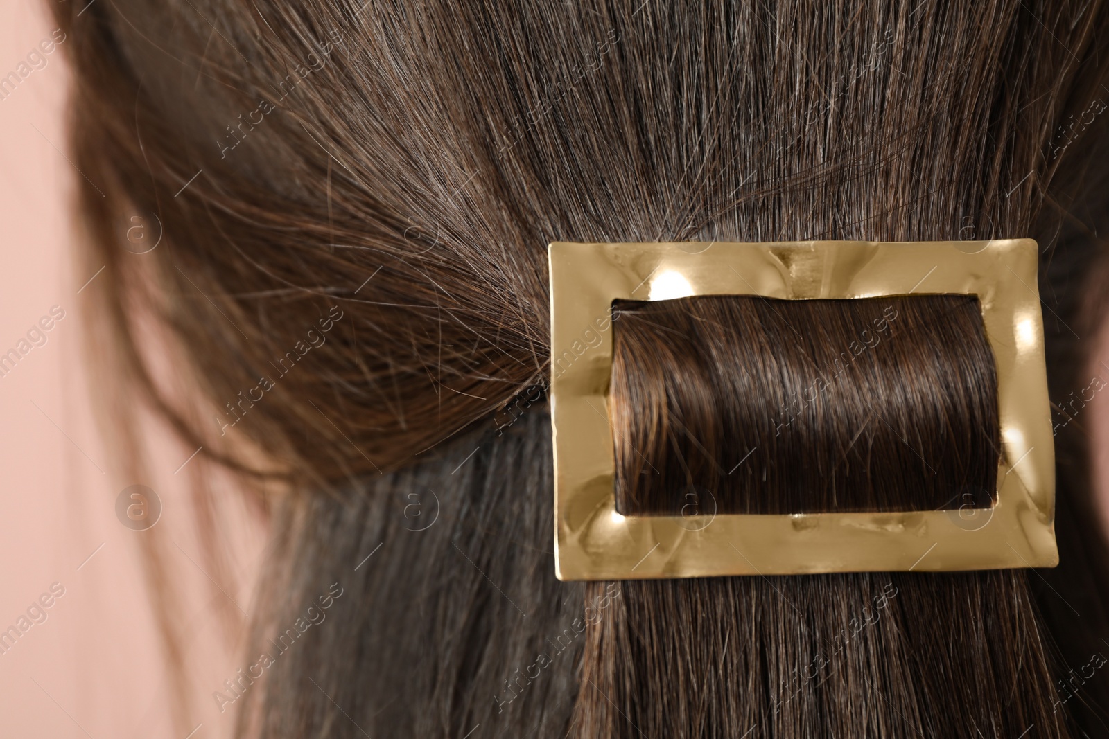 Photo of Woman with beautiful gold hair clip, closeup