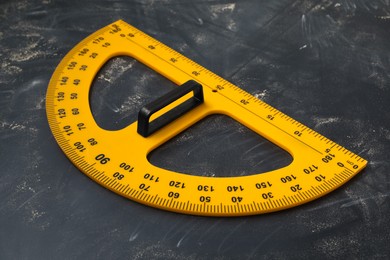 Photo of Protractor with measuring length and degree markings on blackboard