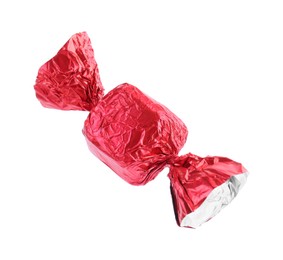 Photo of Tasty candy in red wrapper isolated on white