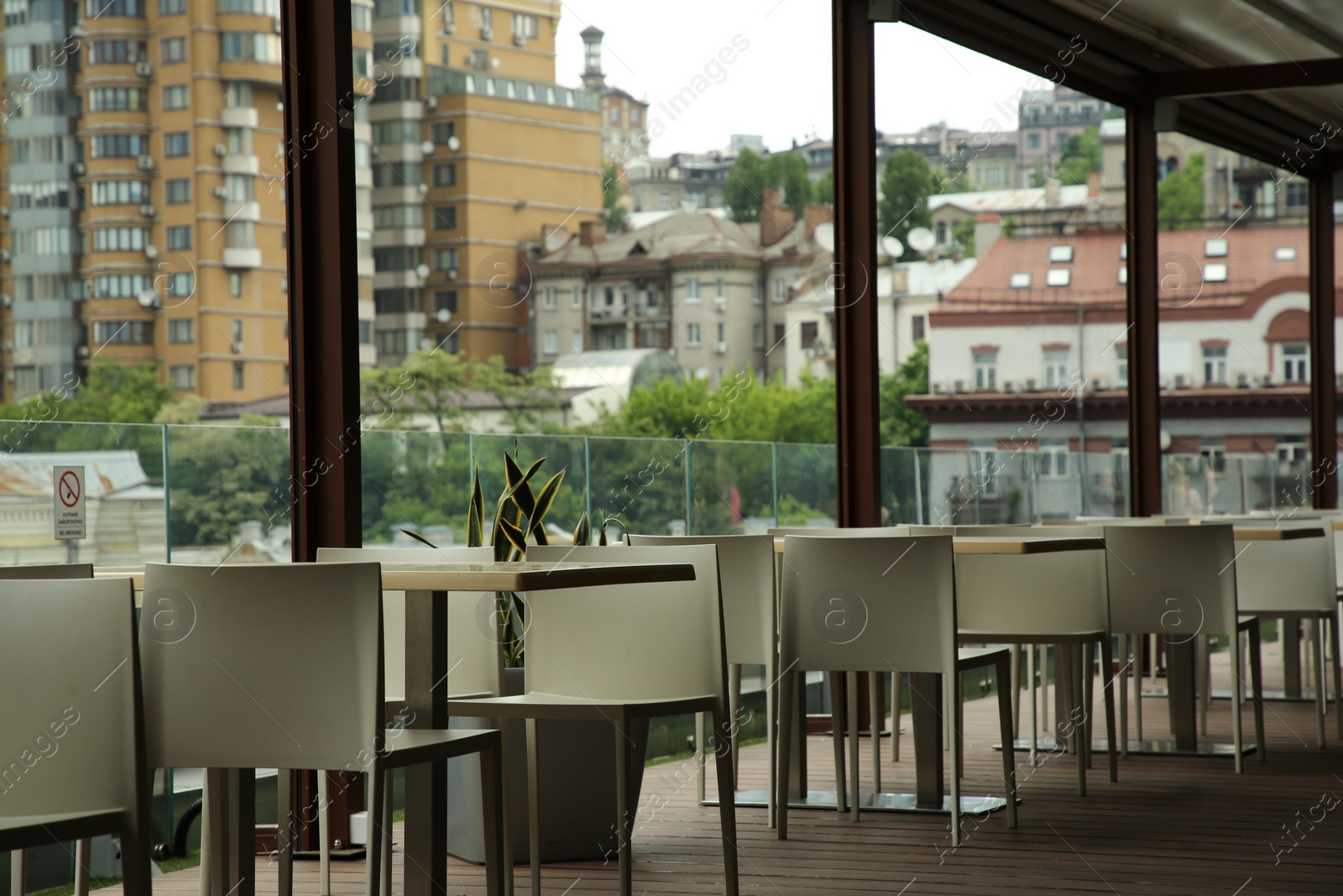 Photo of Observation area cafe. Tables and chairs against beautiful cityscape