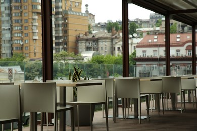 Photo of Observation area cafe. Tables and chairs against beautiful cityscape